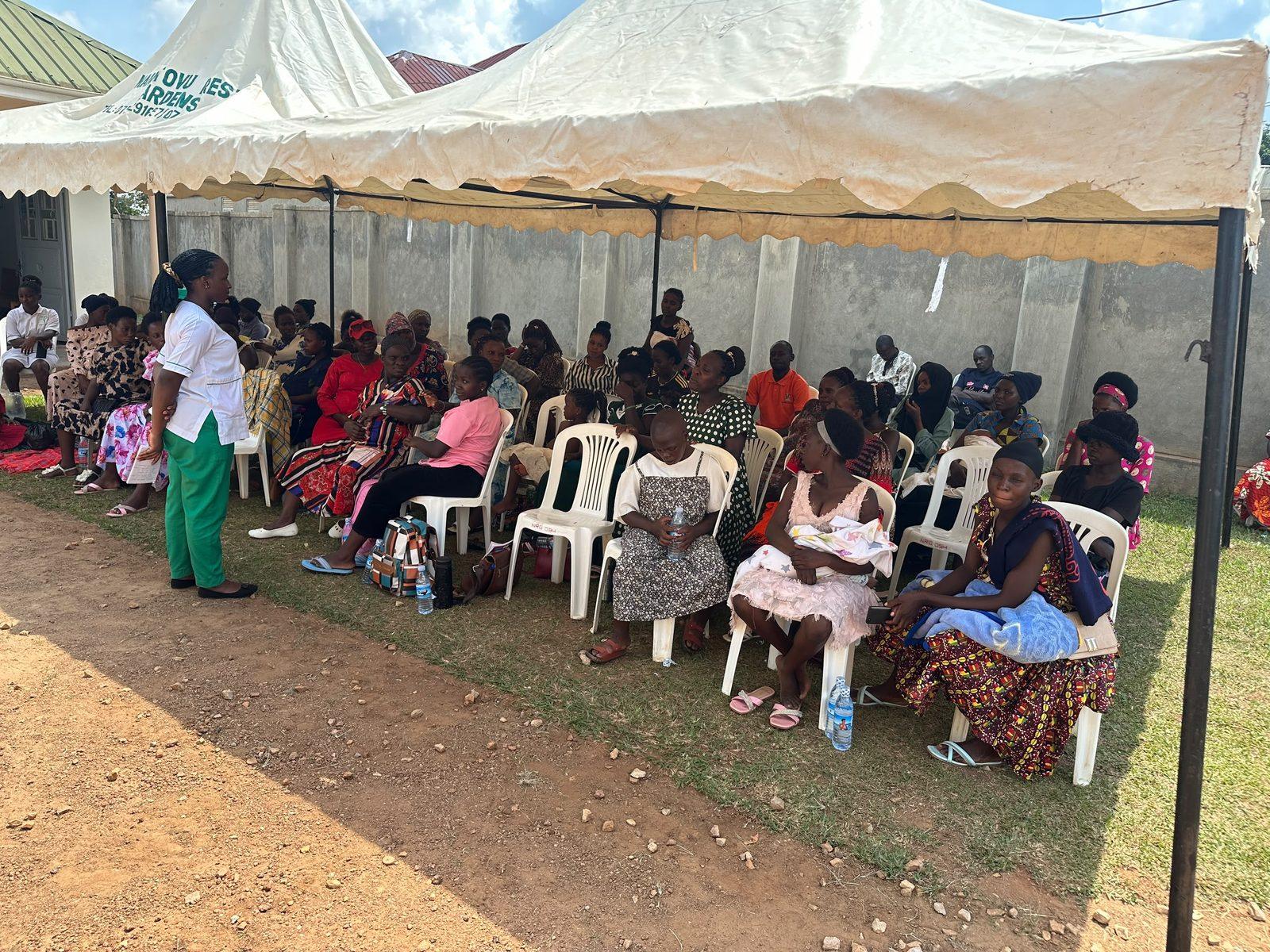 More than 100 mothers seated under a tent at the Maternal and Child Health Outreach